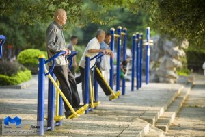 Elderly men exercise at a public outdoor park in Yangshuo, China.